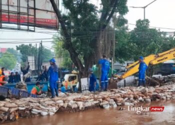 BANJIR: Petugas Satpel Sudin Sumber Daya Air (SDA) Jakarta Timur membuat bronjong dari karung yang berisi pasir sebagai tanggul untuk menahan luapan air Kali Baru, Hek, Kelurahan Tengah, Kecamatan Kramat Jati, Jakarta Timur, Senin, 25 Maret 2024. (Antara/Lingkar.news)