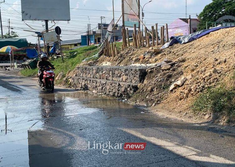 BERKENDARA: Pengendara sedang melintas di area kebocoran tanggul kiri Sungai Jratun tepatnya di depan Masjid Besar Al Madinah Kecamatan Karanganyar, Kabupaten Demak, Minggu, 4 Agustus 2024. (M. Burhanuddin Aslam/Lingkar.news)